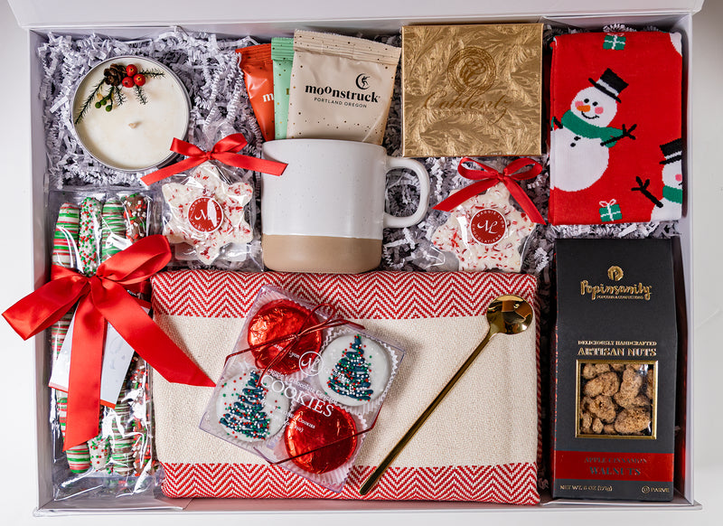 Christmas gift set with hot cocoa, mug, blanket, christmas candle, cookies and pretzels